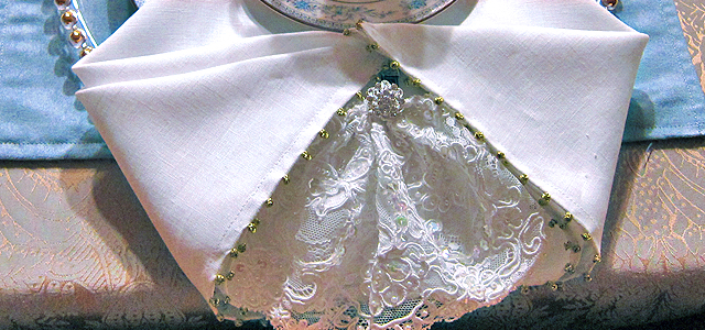 Winter Tablescape Napkin Treatment lace lacy Holiday & Hearth Holiday and Hearth Lisa Novelline Lisa Anne Novelline author writer The Dance of Spring craft blog creative blog creativity decorator blog festival celebration seasons nature blog Winter Christmas Yule yuletide Winter Solstice December napkin clip winter festival winter fair table setting tablescape formal dining embellishment