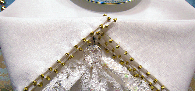 Completed Lacy Napkin Clip on Table Lacy Napkin Clip Finished View Covering Clip With Upper Layers Of Napkin Adjusting Clip Under Napkin Layers Winter Tablescape Napkin Clip Basic Gather Stitch Materials for Winter Tablescape Napkin Clips lace napkins Dransfield Ross Holiday & Hearth Holiday and Hearth Lisa Novelline Lisa Anne Novelline author writer The Dance of Spring craft blog creative blog creativity decorator blog festival celebration seasons nature blog Winter Christmas Yule yuletide Winter Solstice December napkin clip winter festival winter fair table setting tablescape formal dining embellishment
